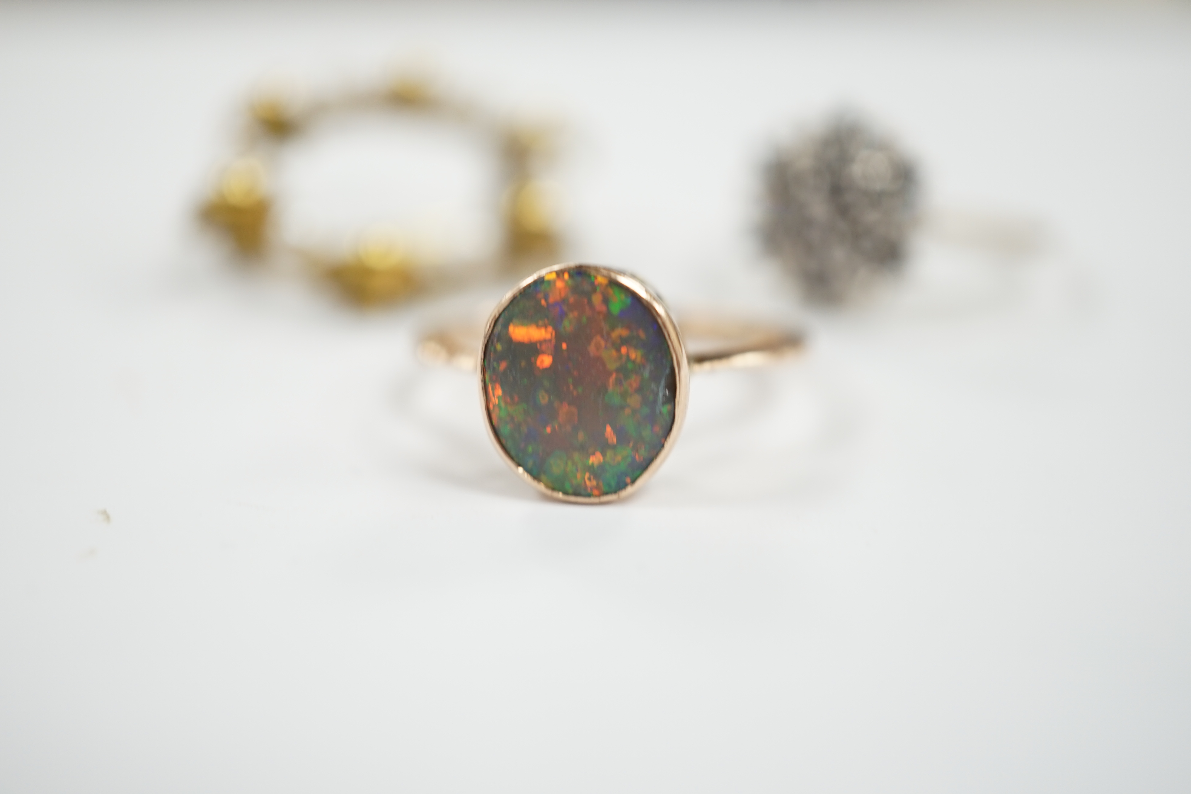 A 9ct gold and two colour sapphire cluster set dress ring, one other 9ct and opal ring and a 9ct gold and cultured pearl set open work circular brooch, gross weight 8.5 grams.